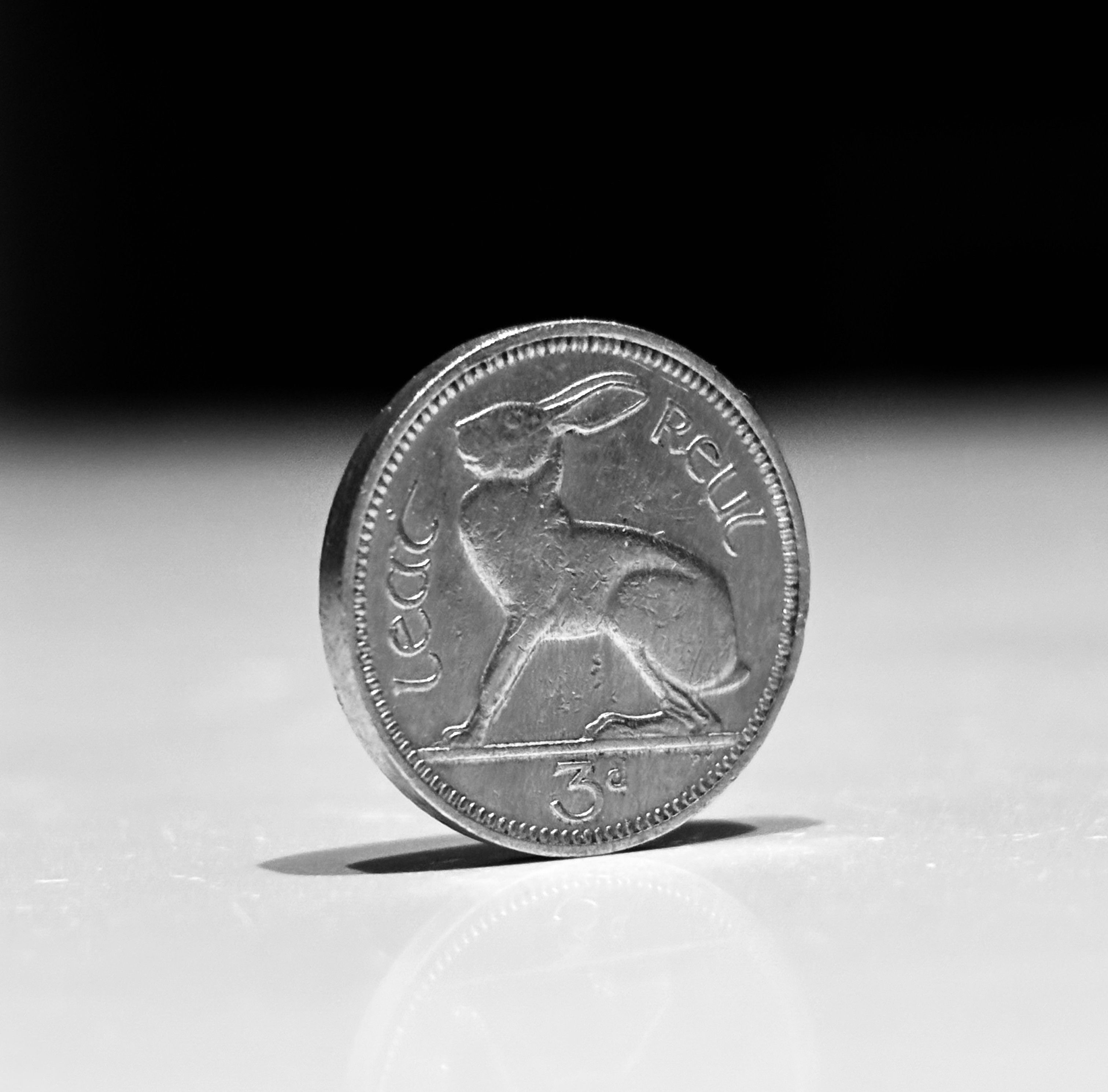 A close-up of an old Irish threepence coin